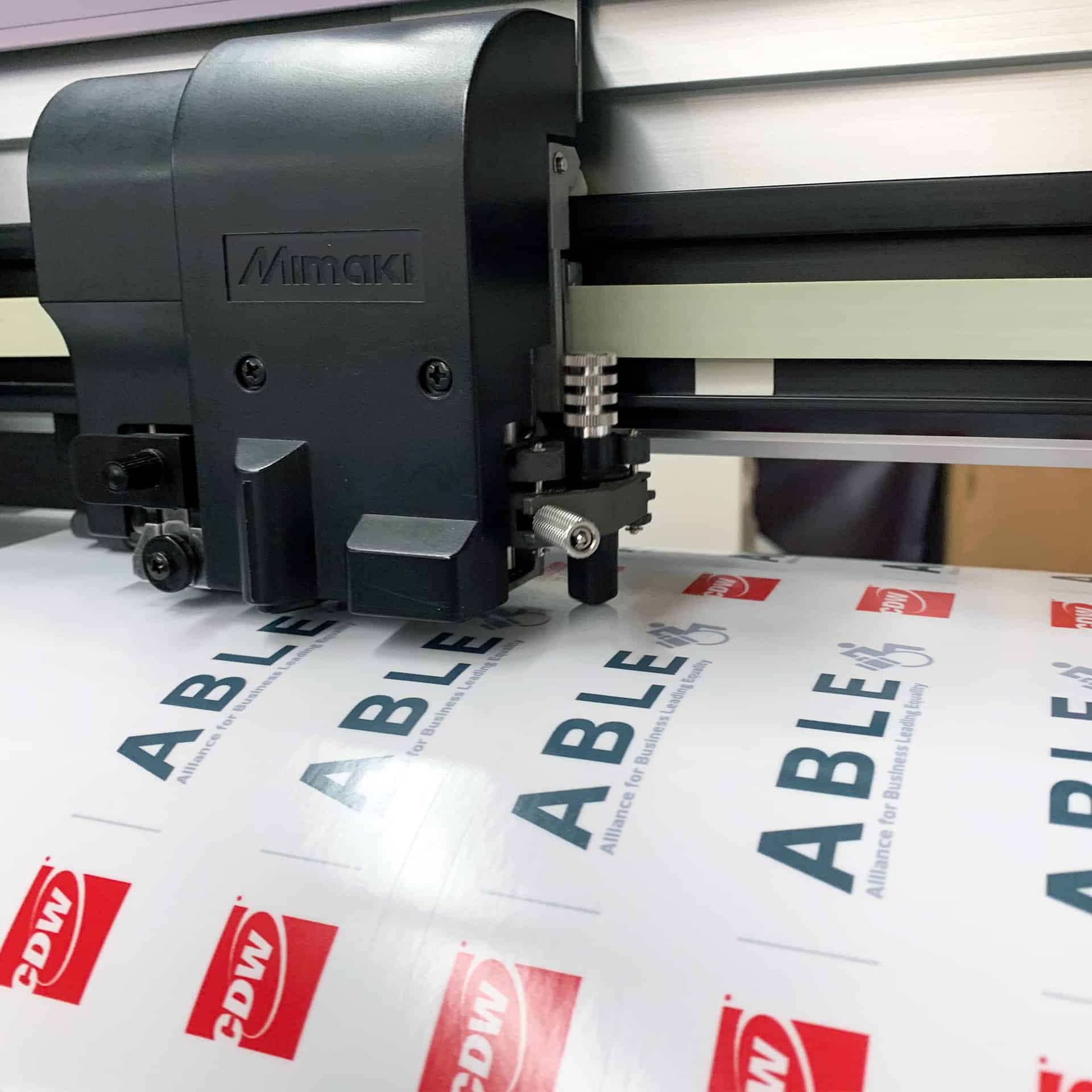 A commercial machine is printing a label on a sheet of paper.