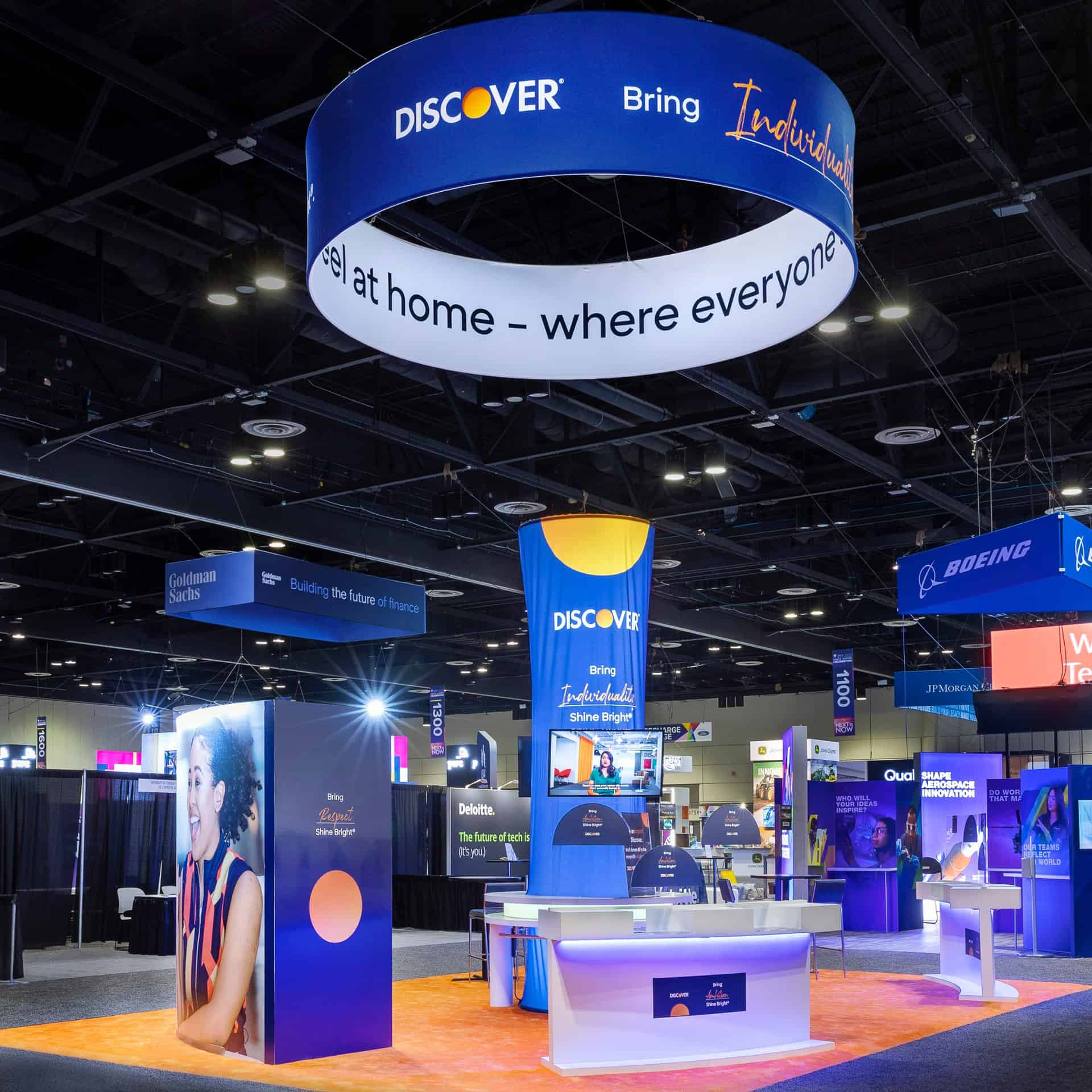A trade show booth featuring a vibrant blue and orange sign showcasing commercial printing services.