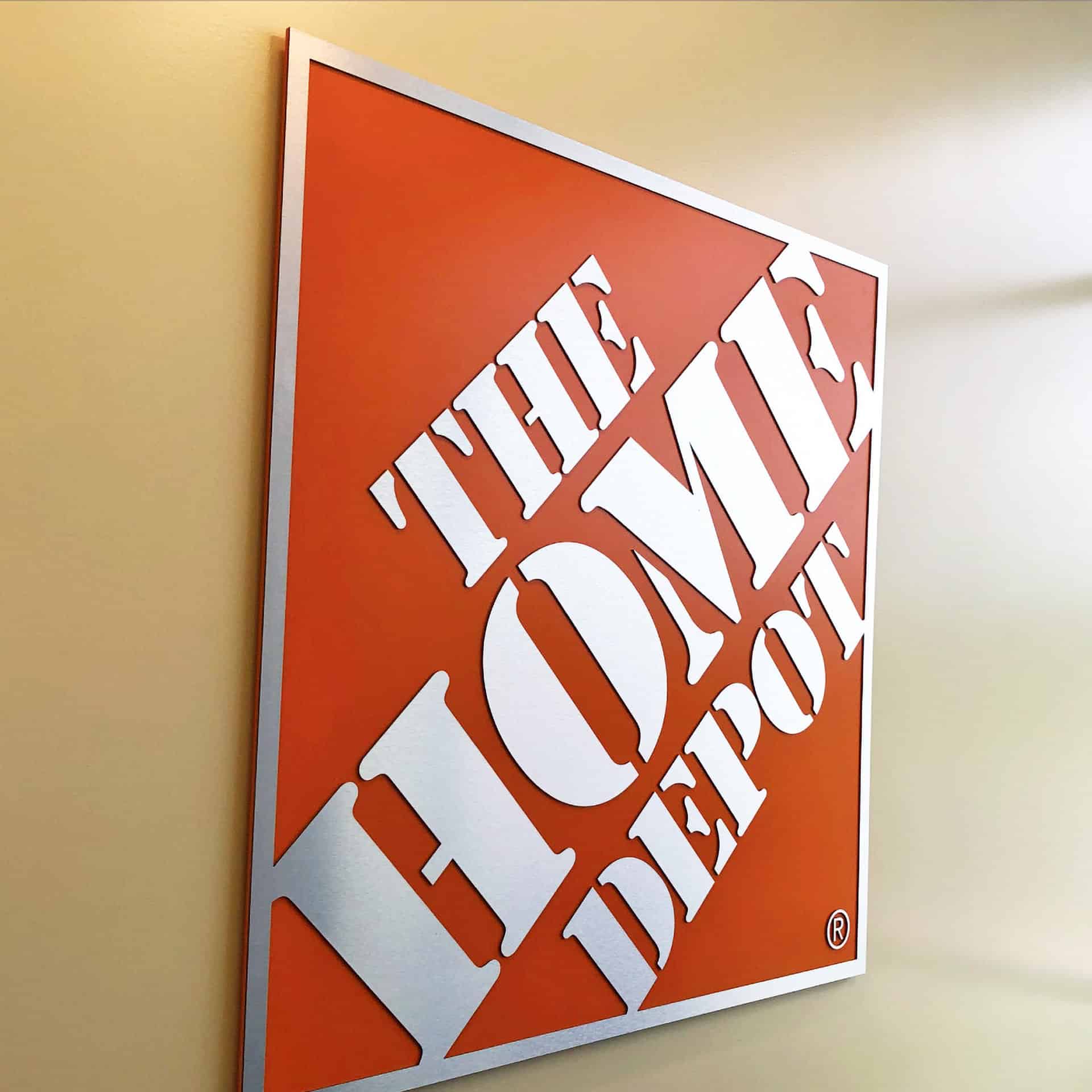 The Home Depot logo sign is hanging on the wall.