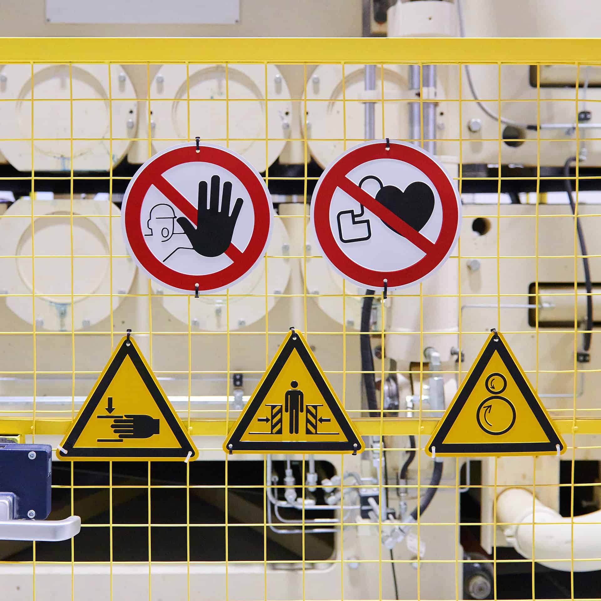 A display of safety signs on a fence.