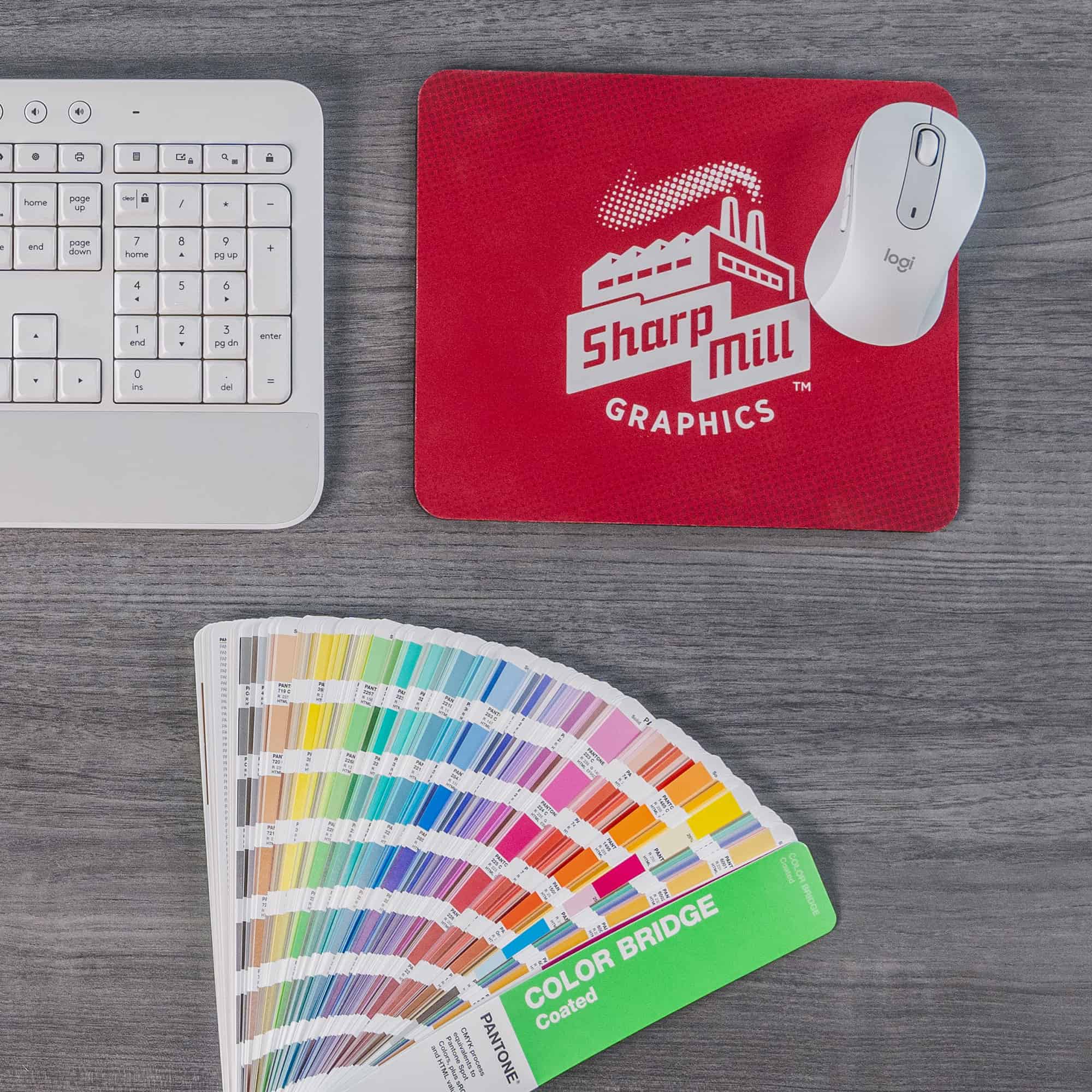 A mouse pad with a color palette and a keyboard.