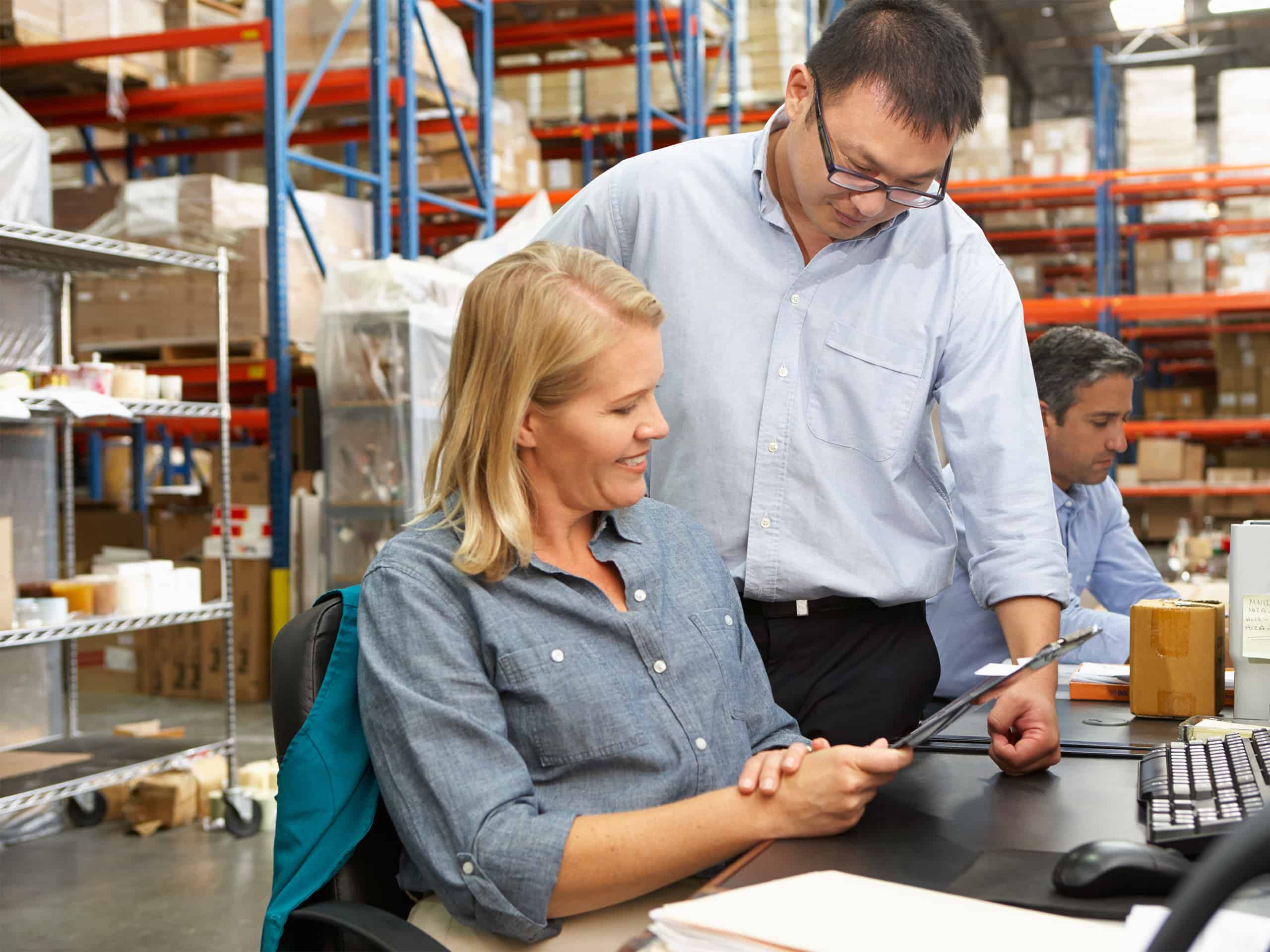 A man and a woman showcasing their expertise in a warehouse.