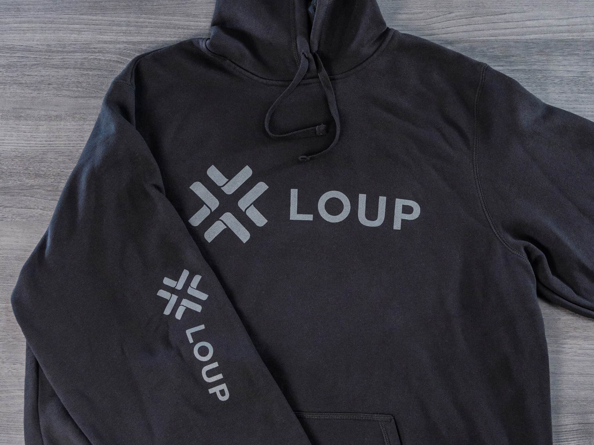 A black hoodie with the word loup on it.