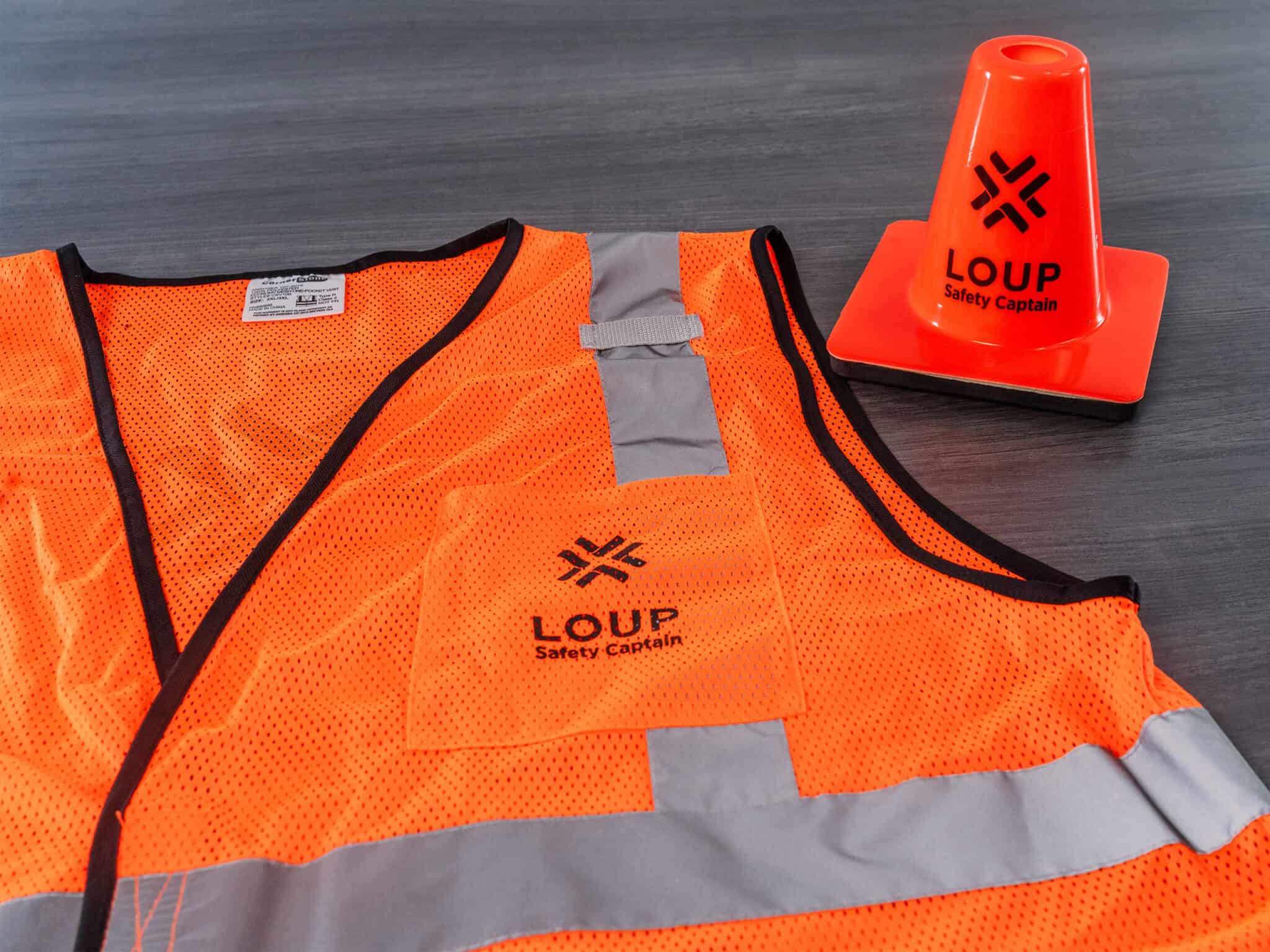 A safety vest with a cone and a cone next to it.