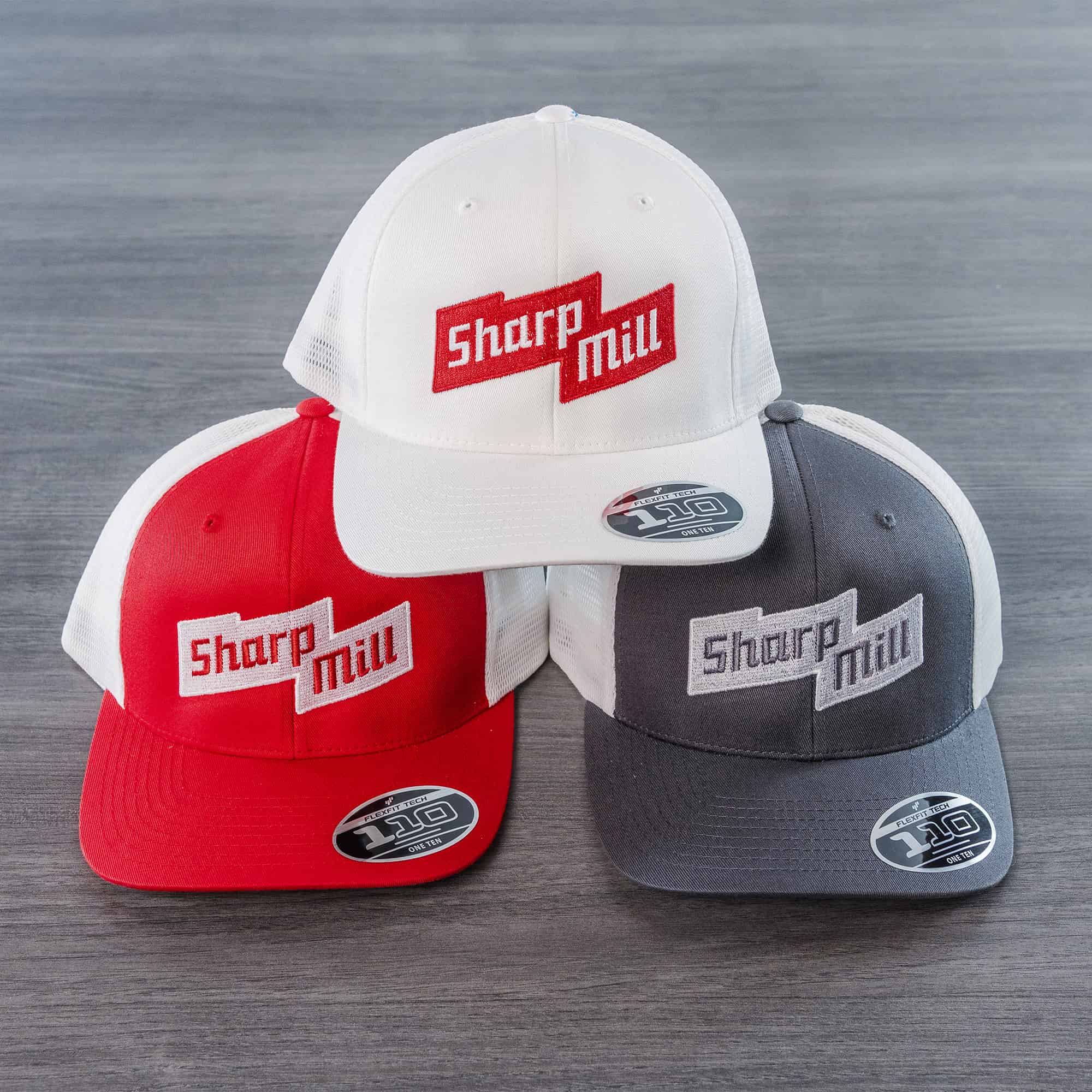 Three hats with the word Sharp Mill on them, used for a project.